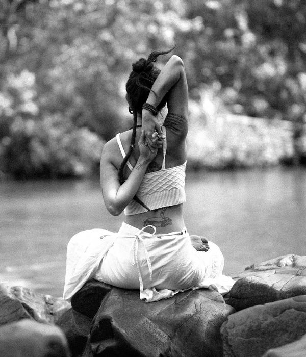Woman in a calm, seated yoga pose, embodying inner balance and strength.